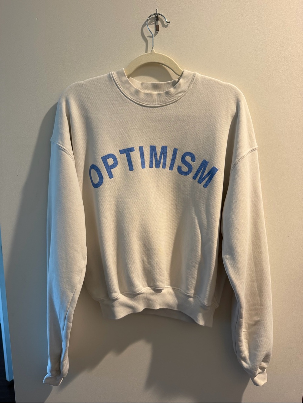 Madhappy Cream Crewneck with Blue "OPTIMISM" Graphic